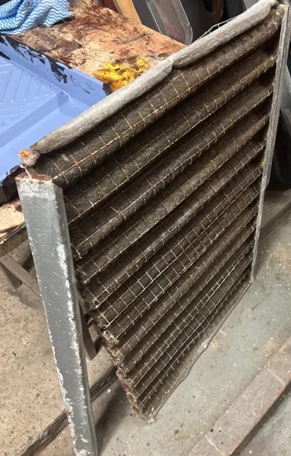 Disintegrated and filthy HVAC filter from a commercial venue, showing the result of years of neglected maintenance by a low-cost competitor.