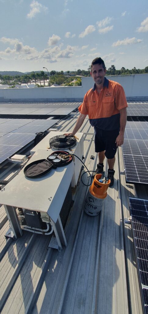 An air-conditioning technician repairing an AC unit