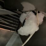 Ice build-up inside a commercial fridge caused by airflow blockage or faulty defrost system
