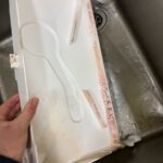 Close-up of pink bacterial growth (Serratia marcescens) on an internal ice machine component, indicating poor hygiene and the need for professional servicing.