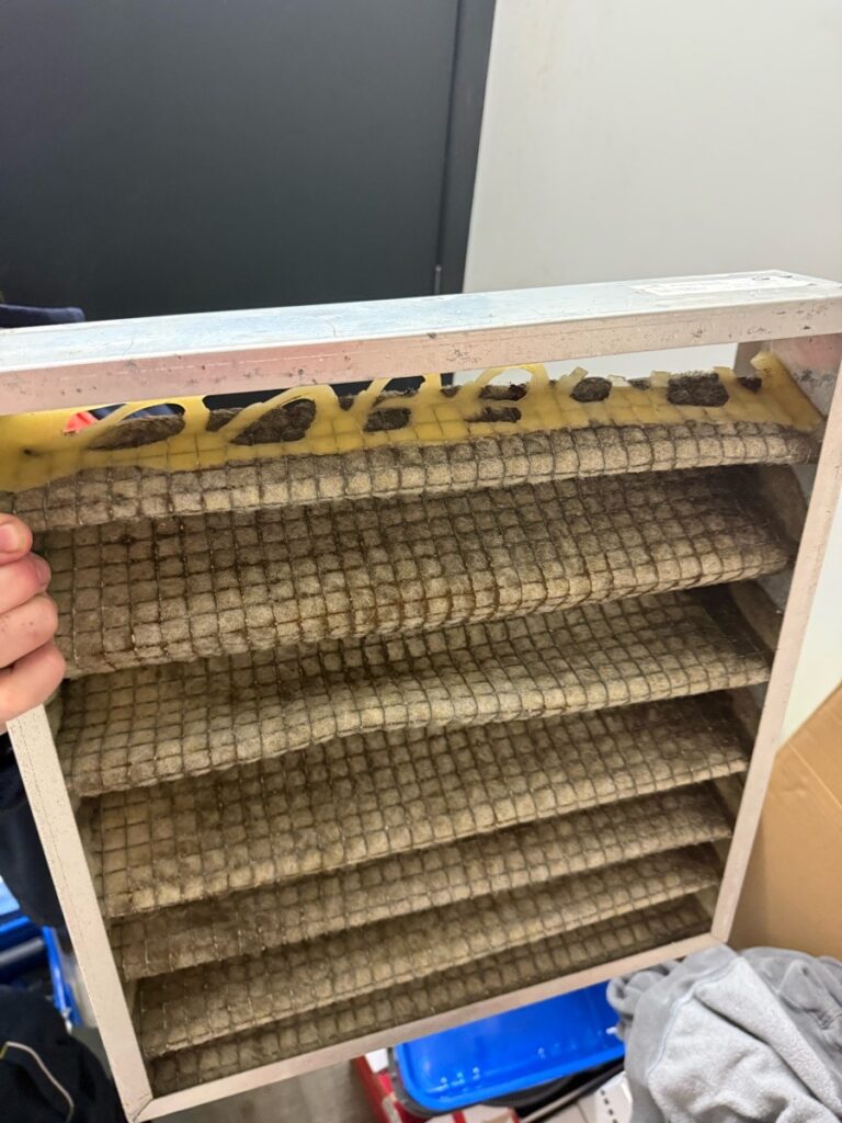Disintegrated and filthy HVAC filter from a commercial venue, showing the result of years of neglected maintenance by a low-cost competitor.