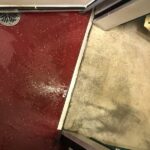 Water leak pooling on the floor of a commercial cold room near refrigeration unit