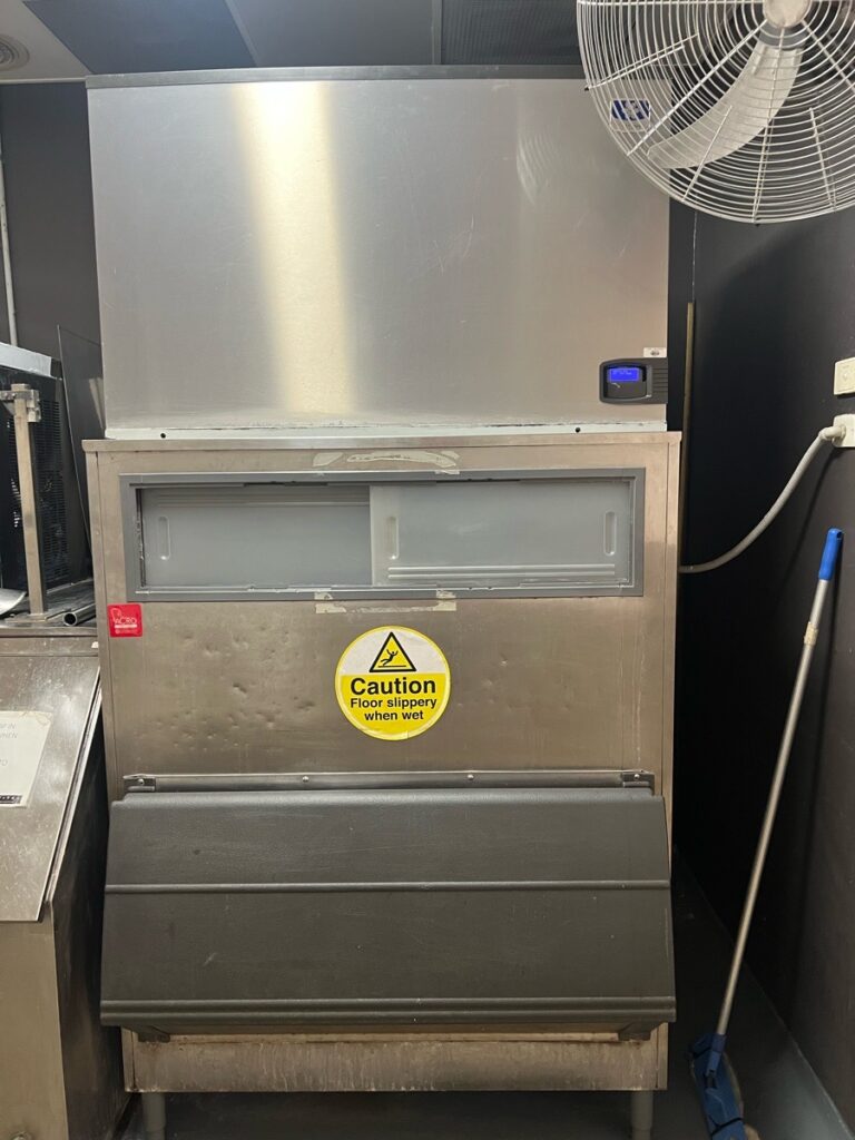 A commercial ice making machine in a hotel