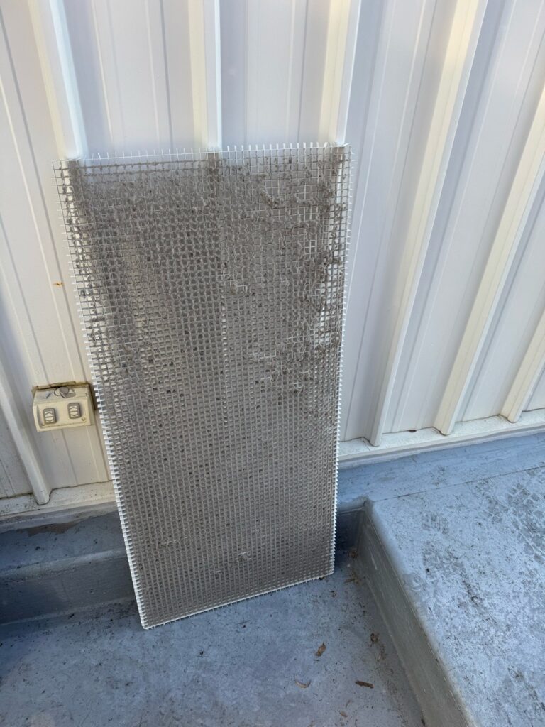 a return air grill covered in dust