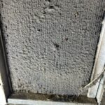 A blocked restaurant fridge condenser coil