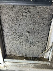 A blocked restaurant fridge condenser coil